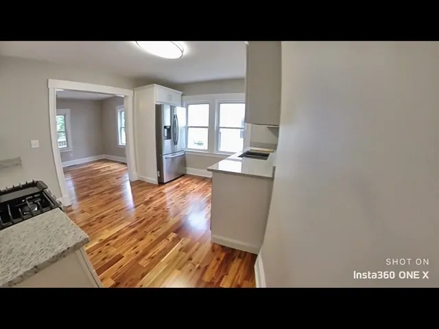 a view of living room with furniture and wooden floor