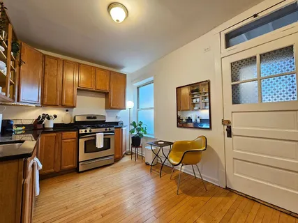 a view of kitchen with microwave and stove top oven