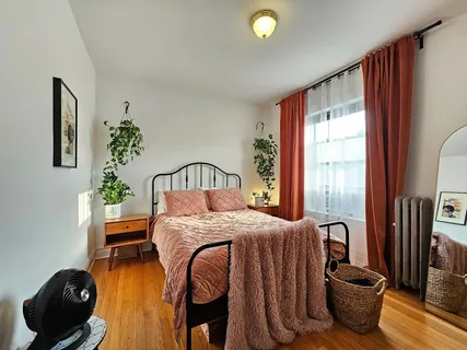 a bedroom with a bed and a large window
