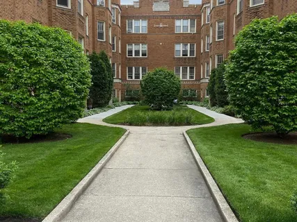 a view of backyard with plants and seating area