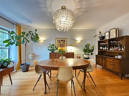 a view of a dining room with furniture and chandelier