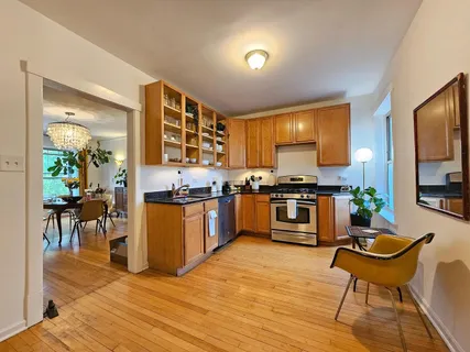 a kitchen with stainless steel appliances kitchen island granite countertop a stove a sink and a microwave