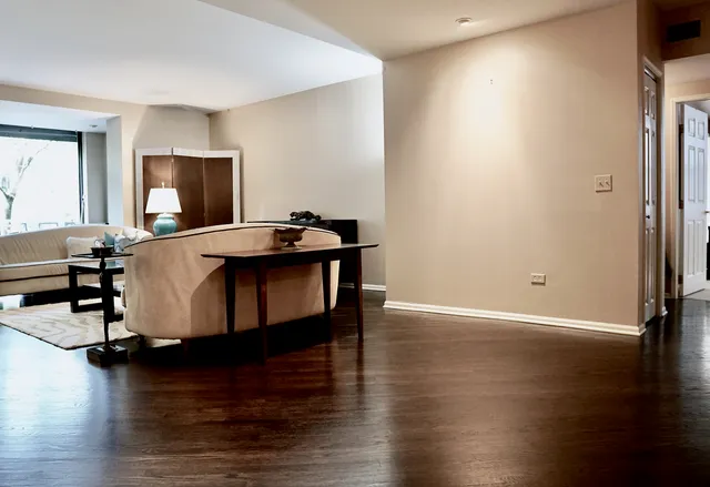 a living room with dining room and wooden floor
