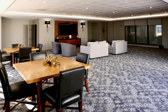 a view of a dining room with furniture and a flat screen tv
