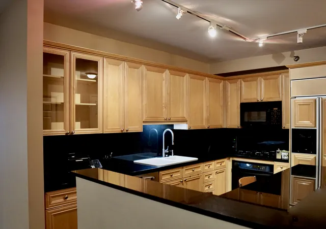 a kitchen with a sink appliances and cabinets