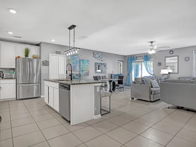 a kitchen with refrigerator and cabinets