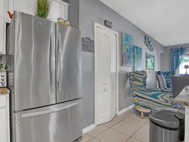 a kitchen with stainless steel appliances granite countertop a refrigerator and a refrigerator