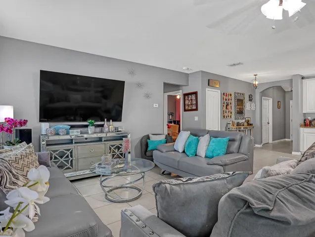 a living room with furniture and a flat screen tv