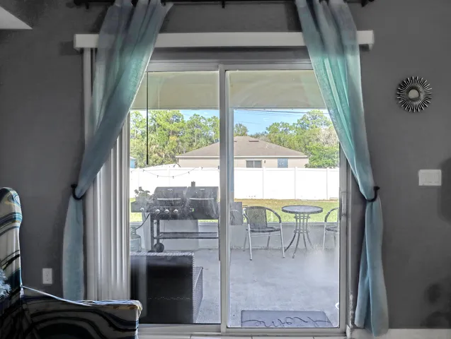 a view of a living room and a floor to ceiling window