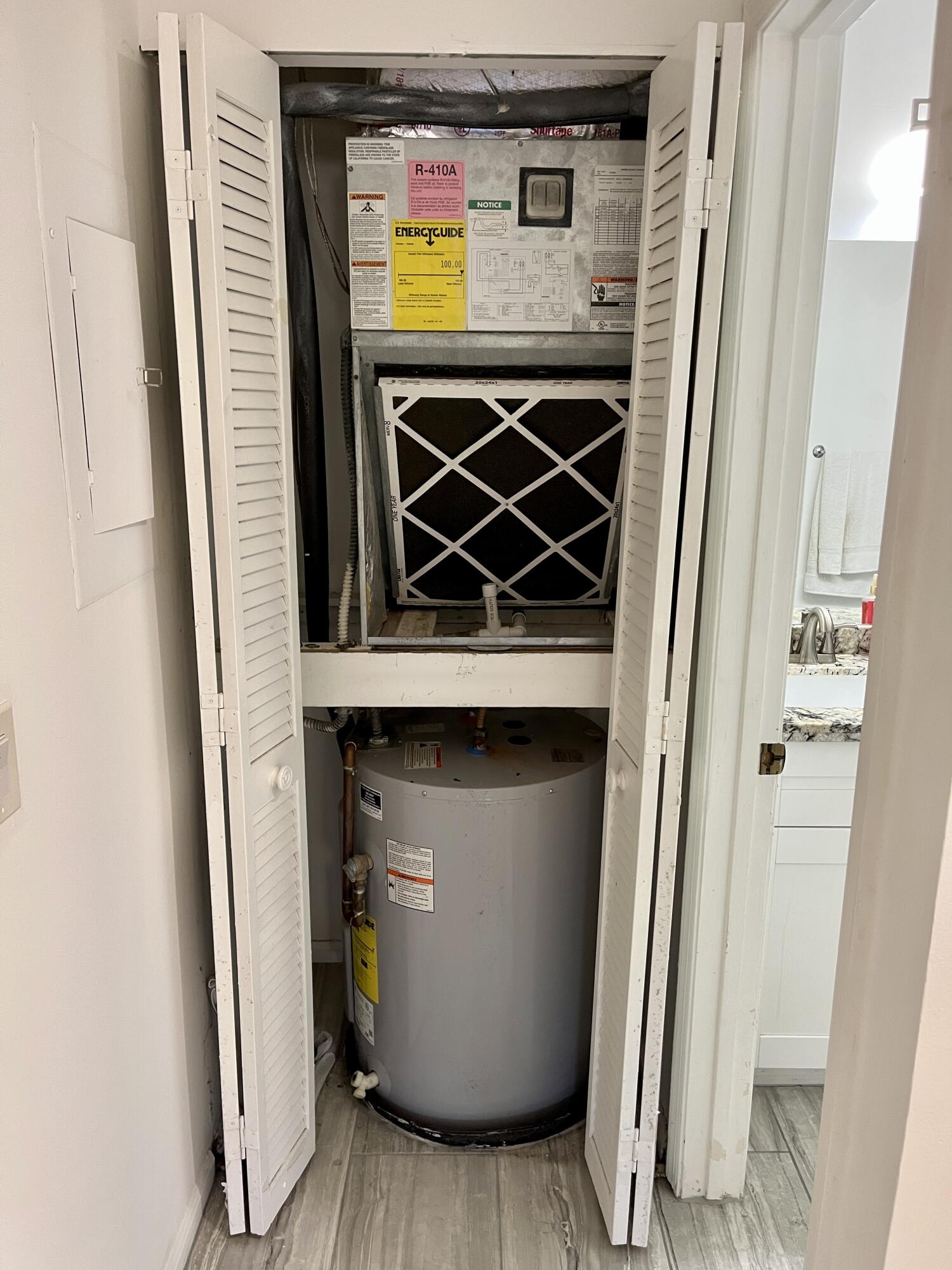 9316 Sable Ridge Circle, Unit B Boca Raton, FL 33428 - Photo 42 of 48 AC unit and water heater