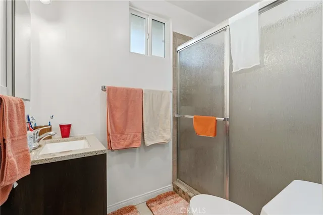 a bathroom with a sink mirror vanity and toilet