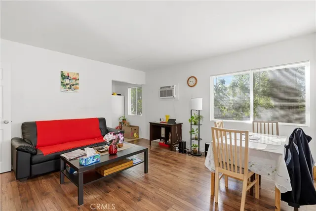 a living room with furniture a red lamp and a floor to ceiling window