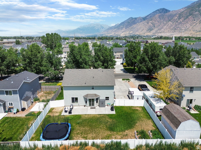 1393 West 150 North Springville, UT 84663 - Photo 27 of 31 Two-story residence featuring a bay window, rear patio, and fenced backyard