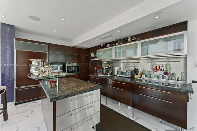 a kitchen with stainless steel appliances granite countertop a sink and cabinets