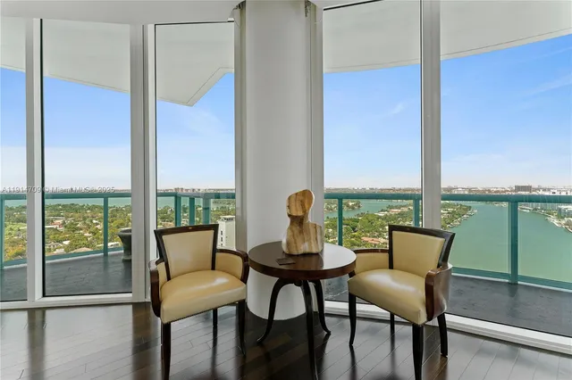 a view of a room with a table and chairs