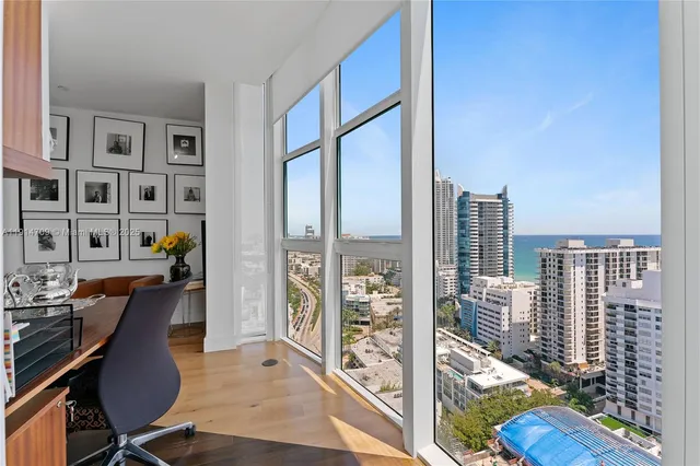 a view of a city from a dining room with furniture