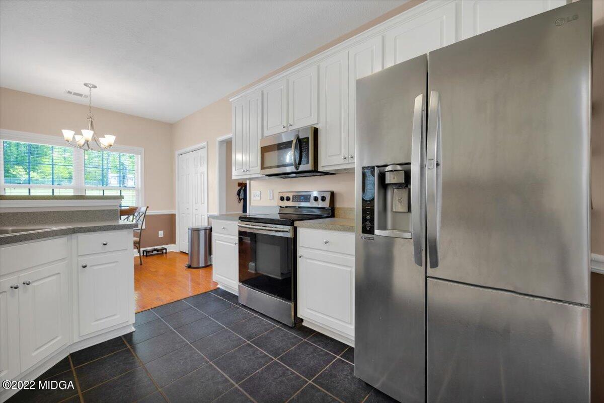 1360 Patterson Road Griffin, GA 30223 - Photo 11 of 24 a kitchen with stainless steel appliances a refrigerator sink and microwave