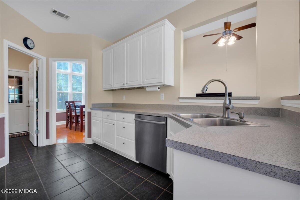1360 Patterson Road Griffin, GA 30223 - Photo 12 of 24 a kitchen with stainless steel appliances granite countertop a sink and a refrigerator