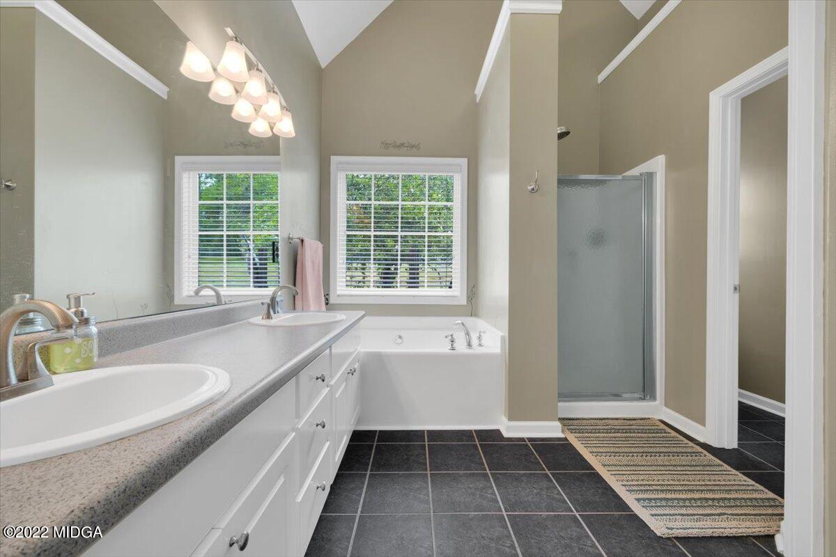 1360 Patterson Road Griffin, GA 30223 - Photo 14 of 24 a bathroom with a tub sink and window