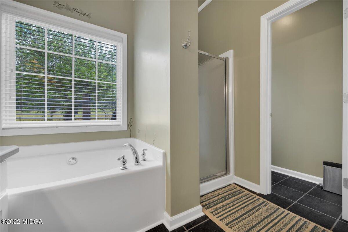 1360 Patterson Road Griffin, GA 30223 - Photo 15 of 24 a bathroom with a bathtub and a shower