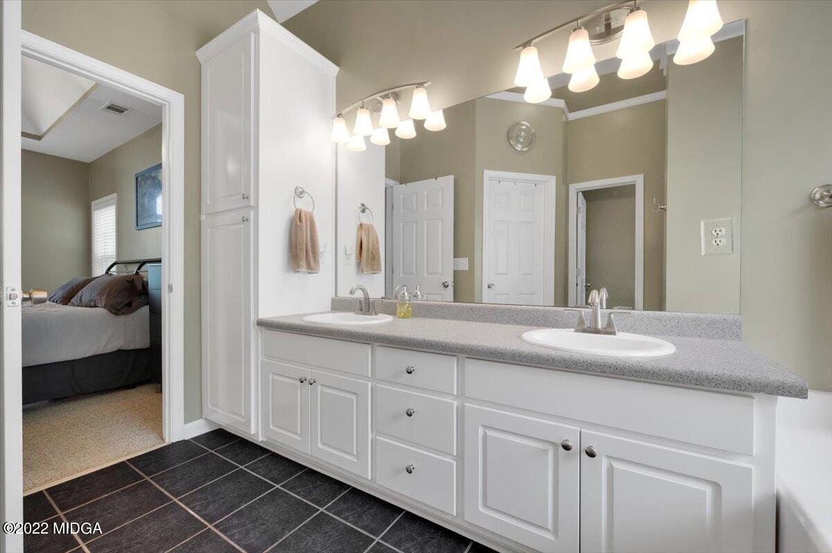 1360 Patterson Road Griffin, GA 30223 - Photo 16 of 24 a en suite bathroom with double sink and a mirror