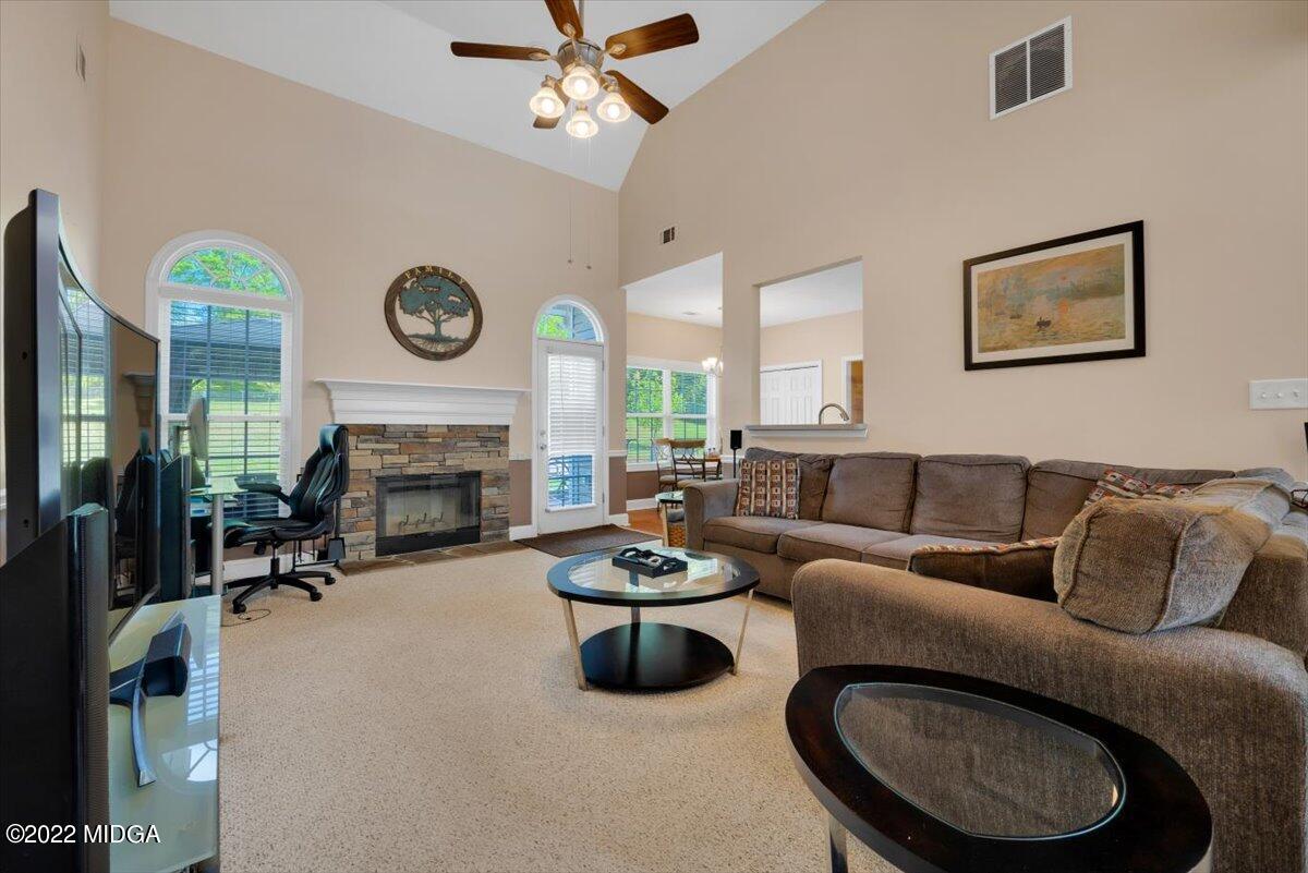 1360 Patterson Road Griffin, GA 30223 - Photo 8 of 24 a living room with furniture a fireplace and a large mirror