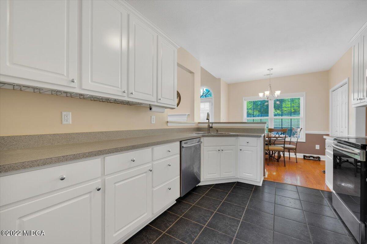 1360 Patterson Road Griffin, GA 30223 - Photo 10 of 24 a kitchen with granite countertop cabinets sink and stainless steel appliances