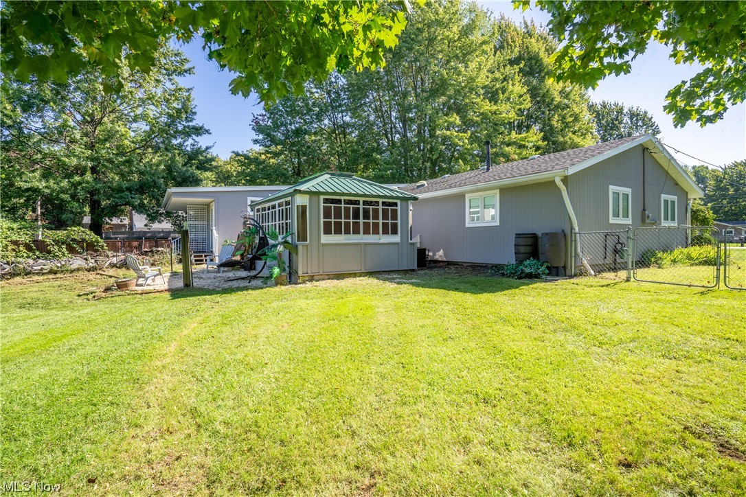44790 Middle Ridge Road Amherst, OH 44001 - Photo 5 of 23 Rear view of house featuring a lawn