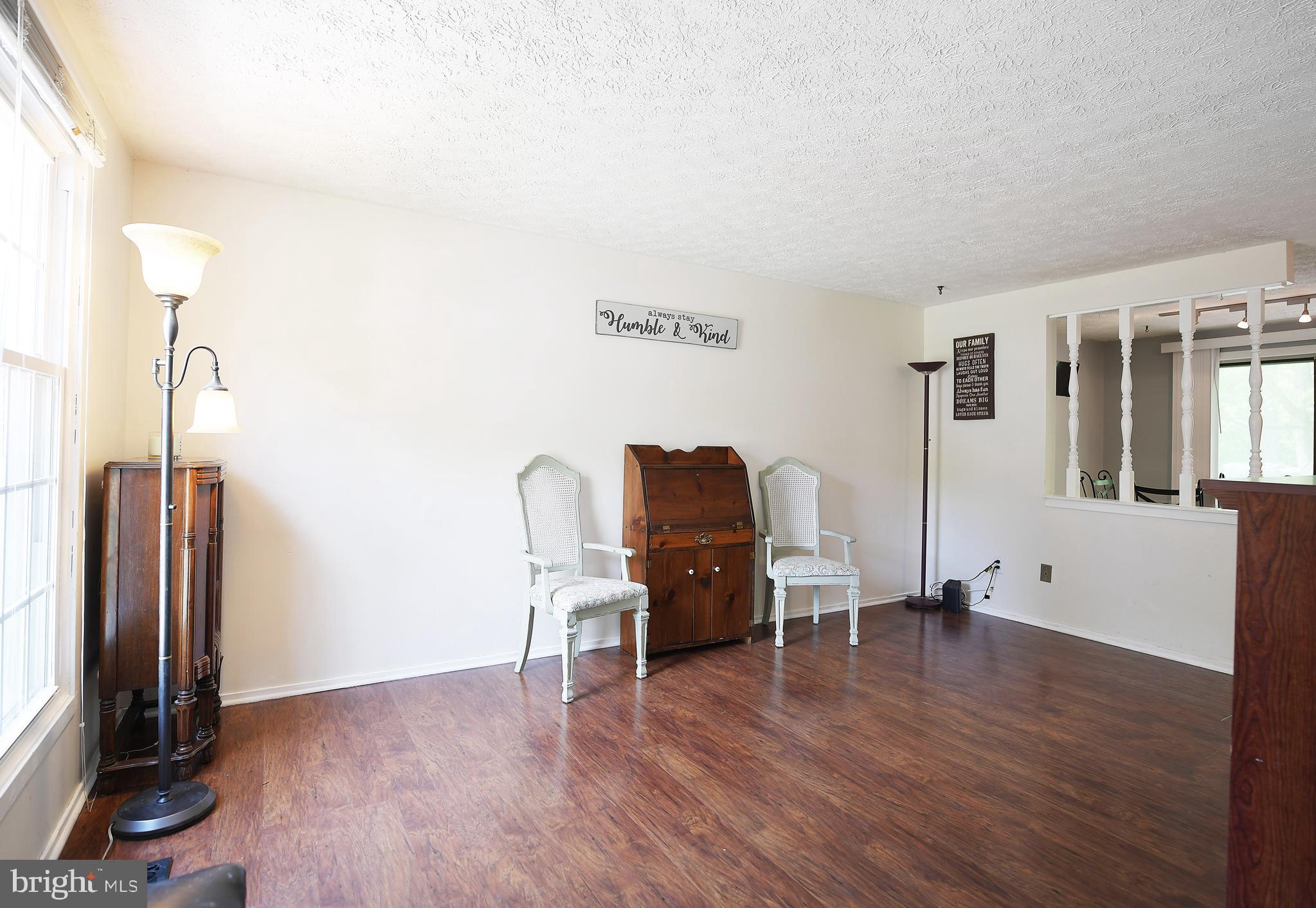 106 Boxthorn Road Abingdon, MD 21009 - Photo 8 of 44 Living room sits at front w dark wood lam flring