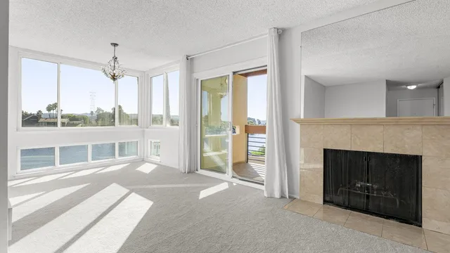 a view of a livingroom with a fireplace and windows