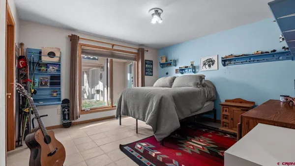 a bedroom with furniture and a book shelf