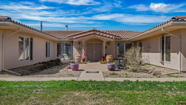 a view of a house with backyard porch and sitting area