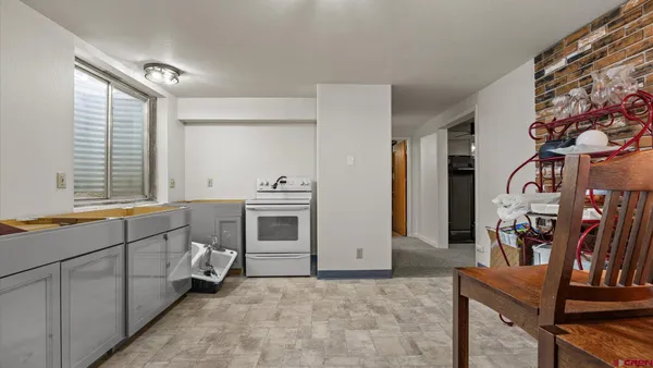 a kitchen with stainless steel appliances a stove a sink and a refrigerator