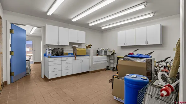 a kitchen that has a lot of cabinets a sink and appliances in it