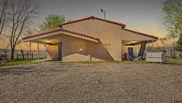 a view of a house with a yard and garage