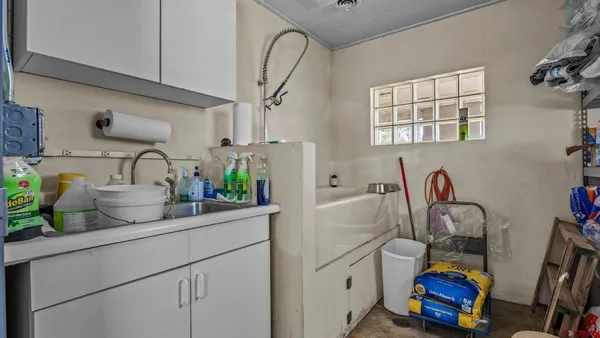 a kitchen with sink refrigerator and stove