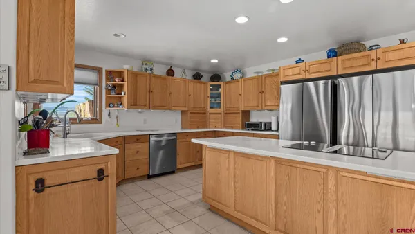 a kitchen with stainless steel appliances granite countertop a sink and cabinets