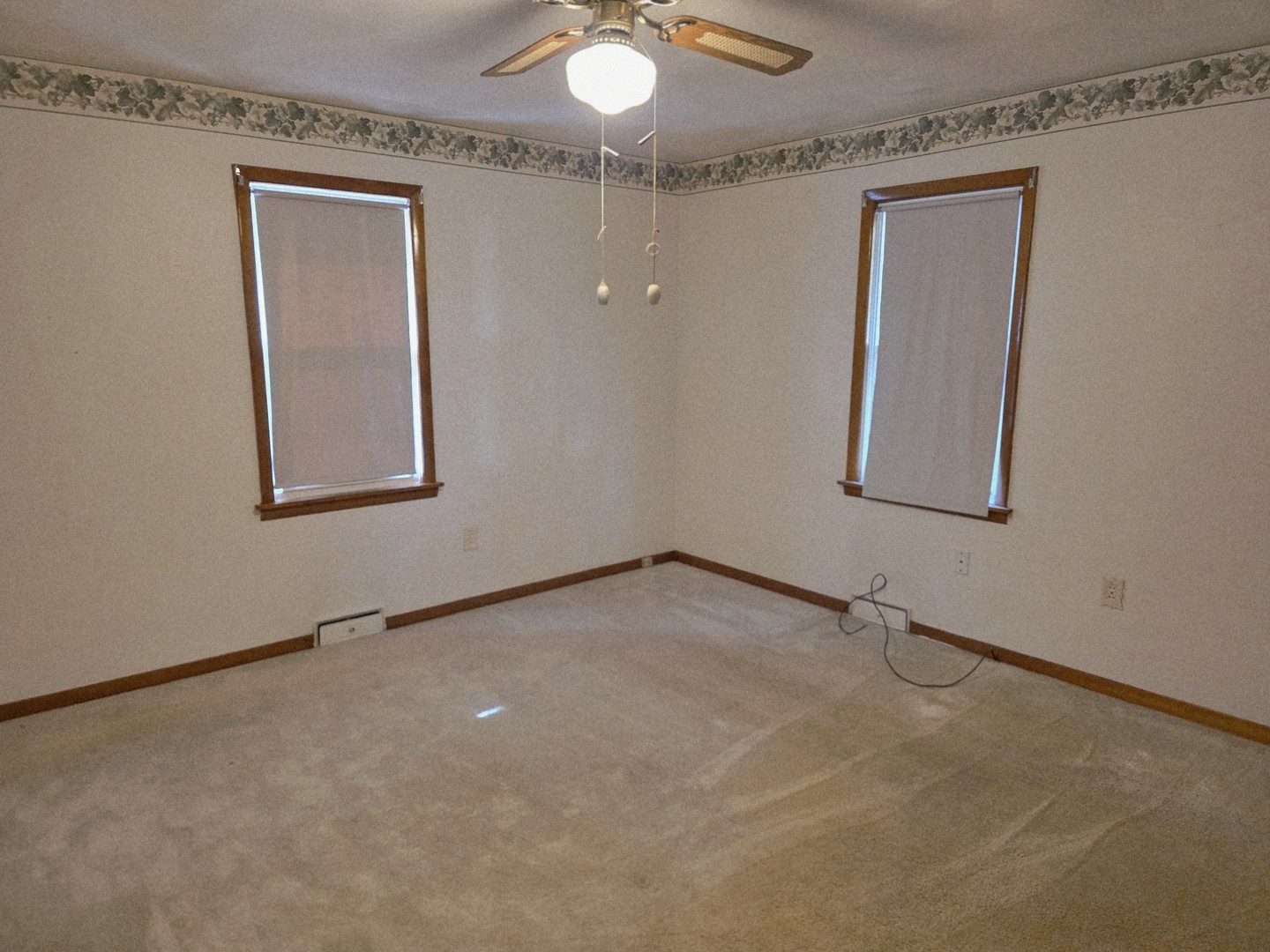 1402 9th Avenue Rock Falls, IL 61071 - Photo 6 of 14 an empty room with a chandelier fan and windows