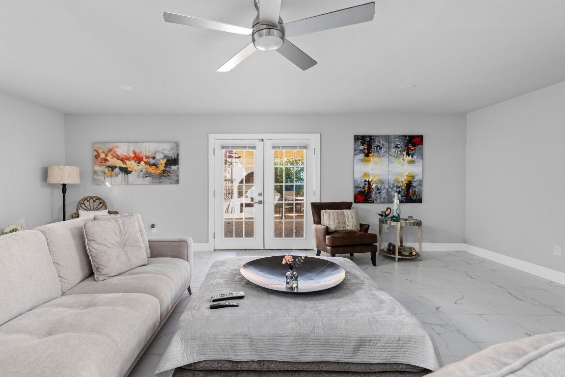 a living room with furniture and a wooden floor