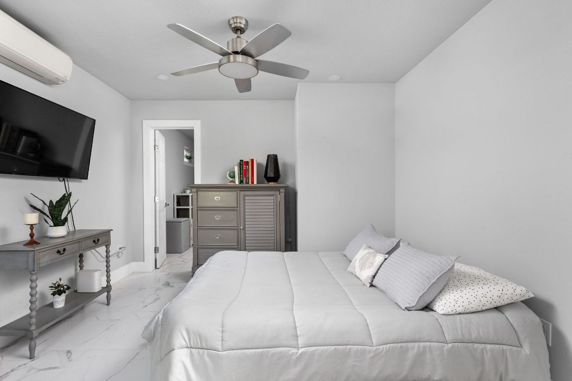 3308 Bengston Street Austin, TX 78702 - Photo 14 of 25 a bedroom with a large bed and a flat screen tv