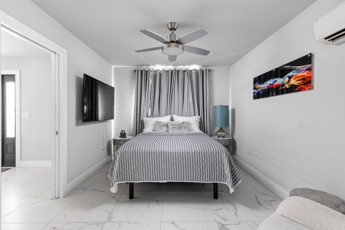 3308 Bengston Street Austin, TX 78702 - Photo 19 of 25 a bedroom with a bed and a flat screen tv