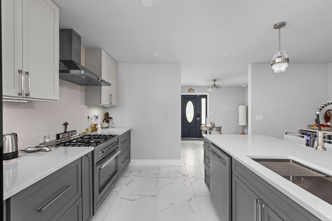 3308 Bengston Street Austin, TX 78702 - Photo 5 of 25 a kitchen with stainless steel appliances a sink stove and cabinets