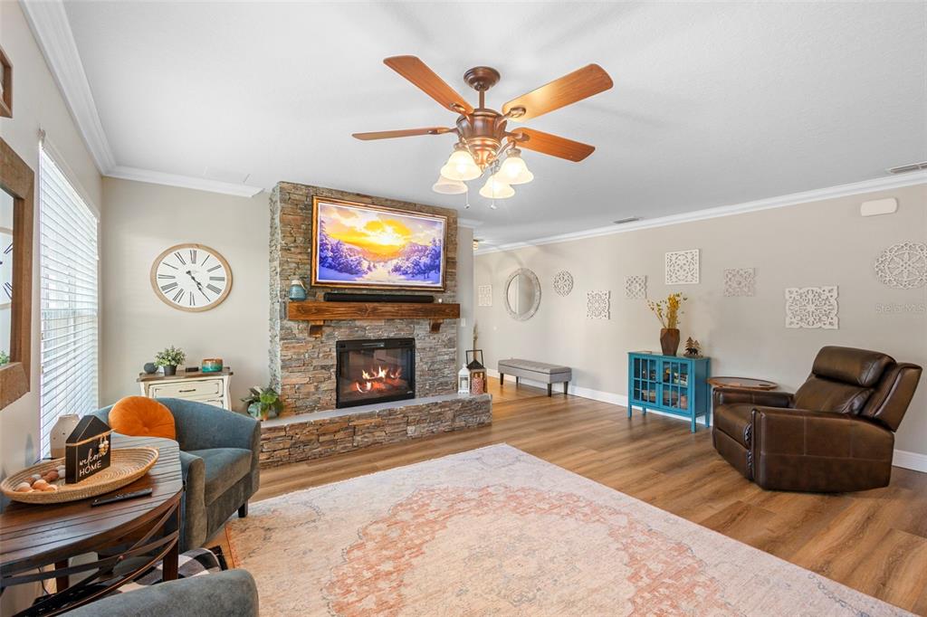 30118 Cheval Street Mount Dora, FL 32757 - Photo 11 of 52 a living room with furniture a fireplace and a flat screen tv