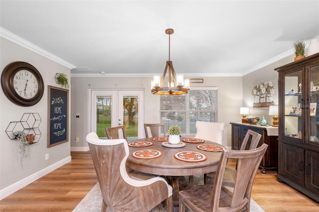 30118 Cheval Street Mount Dora, FL 32757 - Photo 19 of 52 a dining room with furniture a chandelier and wooden floor