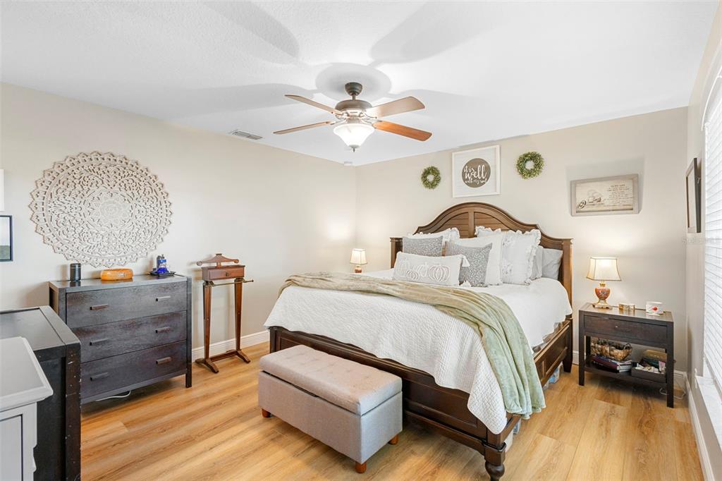 30118 Cheval Street Mount Dora, FL 32757 - Photo 23 of 52 a bedroom with a bed and a chandelier