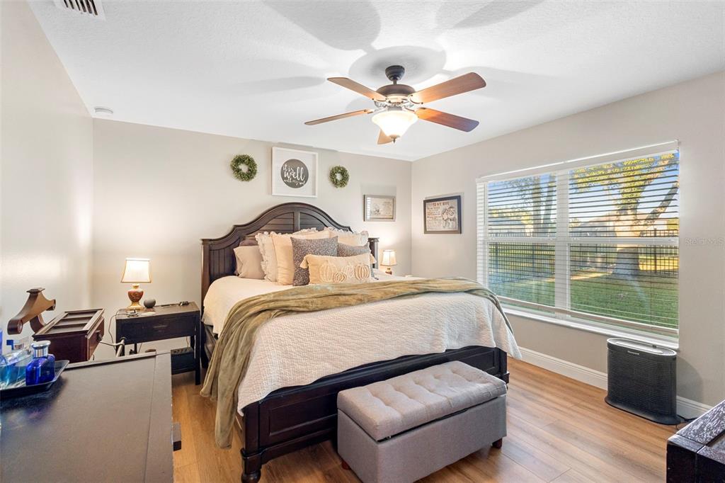 30118 Cheval Street Mount Dora, FL 32757 - Photo 24 of 52 a bedroom with a bed and wooden floor