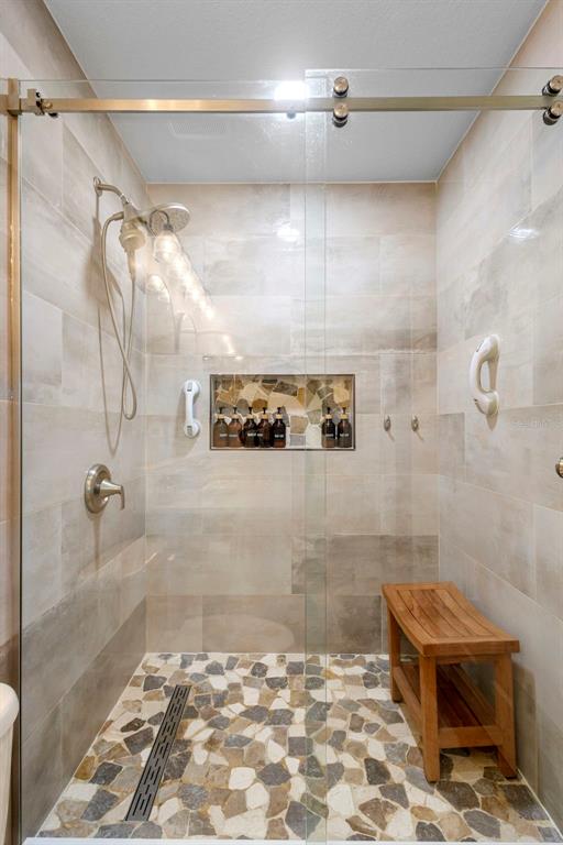 30118 Cheval Street Mount Dora, FL 32757 - Photo 27 of 52 a bathroom with a glass shower door