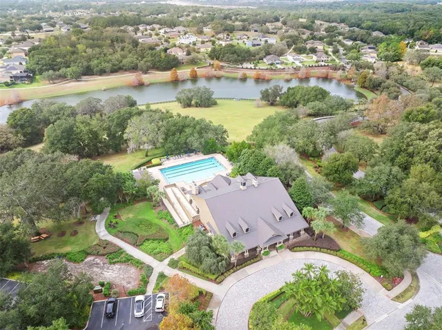 an aerial view of residential houses with outdoor space and river