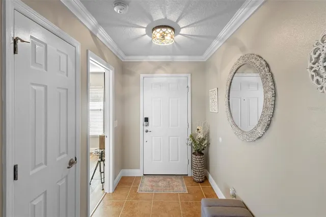 a view of a hallway with wooden floor and a chandelier