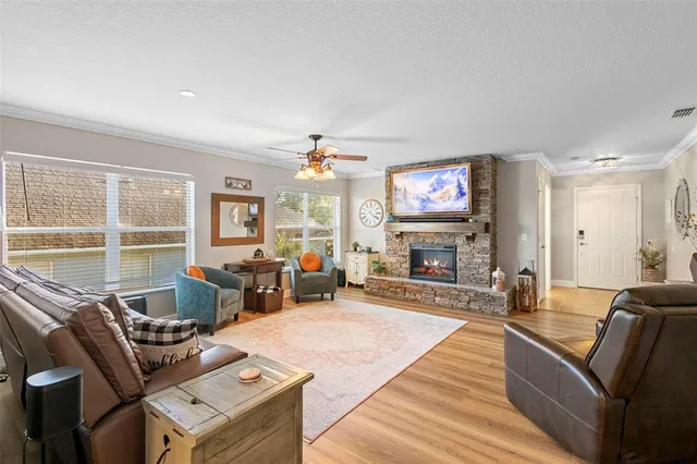 a living room with fireplace furniture and a large window